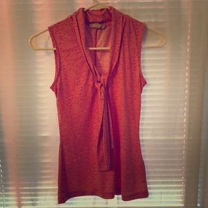 Orange and white polka dot sleeveless blouse